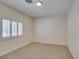 Bright bedroom featuring a window with white shutters and neutral carpeting at 1453 Doggett Ave, Las Vegas, NV 89123
