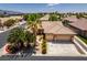 An aerial view of a home with a three-car garage and manicured landscaping creates an inviting curb appeal at 1453 Doggett Ave, Las Vegas, NV 89123