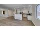 Kitchen and living room combination features stainless appliances, granite counters, and wood flooring at 1453 Doggett Ave, Las Vegas, NV 89123