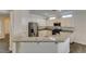 Bright eat-in kitchen boasts granite countertops, stainless steel appliances, and white cabinetry at 1453 Doggett Ave, Las Vegas, NV 89123