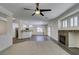 Bright, open floor plan showcasing living room with stone fireplace and partial view of kitchen at 1453 Doggett Ave, Las Vegas, NV 89123