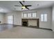 Spacious living room with a stone fireplace, ceiling fan, and shuttered windows at 1453 Doggett Ave, Las Vegas, NV 89123