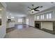 Open-concept living room featuring a fireplace, ceiling fan, and view of the kitchen at 1453 Doggett Ave, Las Vegas, NV 89123