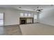 Spacious living room features a stone fireplace, new carpet, and an elegant ceiling fan at 1453 Doggett Ave, Las Vegas, NV 89123