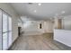 Bright, open living room with wood floors, fireplace, ceiling fan, and shuttered windows, creating an inviting space at 1453 Doggett Ave, Las Vegas, NV 89123