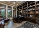 Luxurious home office featuring custom built-in shelves and large windows offering ample natural light at 15 Golden Sunray Ln, Las Vegas, NV 89135