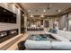 Open-concept living room featuring a fireplace, TV, and views into gourmet kitchen with bar seating at 15 Golden Sunray Ln, Las Vegas, NV 89135