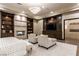 Bright bedroom featuring a modern fireplace, custom built-ins, and comfortable seating area at 15 Golden Sunray Ln, Las Vegas, NV 89135