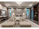 Spacious primary bedroom with a decorative lighting fixture, sitting area and elegant decor at 15 Golden Sunray Ln, Las Vegas, NV 89135