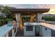 Outdoor kitchen featuring a grill, sink, refrigerator, and counter space, ideal for outdoor cooking and gatherings at 15 Golden Sunray Ln, Las Vegas, NV 89135