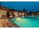 An expansive pool is surrounded by outdoor lounge and dining areas, creating an inviting outdoor space at 15 Golden Sunray Ln, Las Vegas, NV 89135