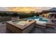 Inviting backyard showcasing a luxurious pool and spa area with mountain views at sunset at 15 Golden Sunray Ln, Las Vegas, NV 89135