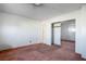 Bedroom featuring mirrored closet doors and worn carpet at 1716 Luning Dr, Las Vegas, NV 89106