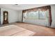 Inviting living room with a large window, vintage curtains, and neutral-toned carpet for a cozy atmosphere at 1716 Luning Dr, Las Vegas, NV 89106