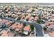 Overhead view of a house and surrounding neighborhood with a view of swimming pools at 1826 Monte Alban Dr, North Las Vegas, NV 89031