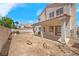 Two-story home back exterior with covered patio and desert landscaping at 1826 Monte Alban Dr, North Las Vegas, NV 89031