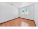 This bright bedroom features hardwood floors and a window with natural light at 1826 Monte Alban Dr, North Las Vegas, NV 89031
