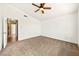 Bright bedroom featuring neutral carpet, ceiling fan, and fresh white walls at 1826 Monte Alban Dr, North Las Vegas, NV 89031