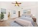 Staged bedroom featuring a ceiling fan, art, bed, and hallway access at 1826 Monte Alban Dr, North Las Vegas, NV 89031
