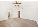 This empty bedroom features neutral carpet, white walls, and a ceiling fan at 1826 Monte Alban Dr, North Las Vegas, NV 89031