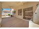 Covered patio featuring fan and sliding glass doors leading to backyard at 1826 Monte Alban Dr, North Las Vegas, NV 89031