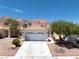 Charming two-story home featuring a well-maintained front yard and a spacious two-car garage at 1826 Monte Alban Dr, North Las Vegas, NV 89031