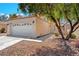 Charming one story home featuring a well-maintained front yard and a spacious two-car garage at 1826 Monte Alban Dr, North Las Vegas, NV 89031