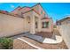 Attractive stucco home with arched entry and well-maintained desert landscaping at 1826 Monte Alban Dr, North Las Vegas, NV 89031