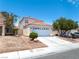 Inviting two-story home with a two-car garage and desert-style landscaping at 1826 Monte Alban Dr, North Las Vegas, NV 89031