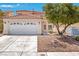 Charming two-story home featuring a spacious two-car garage and classic stucco facade at 1826 Monte Alban Dr, North Las Vegas, NV 89031