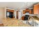 Kitchen features granite countertops, tile backsplash, stainless steel sink and black appliances at 1826 Monte Alban Dr, North Las Vegas, NV 89031