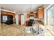 Kitchen showcases granite counters, wood cabinets, black appliances, tile floors, and bright, modern lighting at 1826 Monte Alban Dr, North Las Vegas, NV 89031