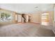 Open-concept living room with plush carpeting, neutral paint, and abundant natural light at 1826 Monte Alban Dr, North Las Vegas, NV 89031