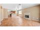 Open-concept living area with stone fireplace, tile flooring, and easy access to the adjacent kitchen at 1826 Monte Alban Dr, North Las Vegas, NV 89031