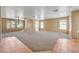 Expansive living room showcasing neutral colors, carpet, and many windows for natural light at 1826 Monte Alban Dr, North Las Vegas, NV 89031