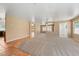 Large open-plan room with tile and carpet flooring and a view to the kitchen at 1826 Monte Alban Dr, North Las Vegas, NV 89031