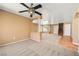 Open living space features neutral colors and carpet flooring leading to an upper level at 1826 Monte Alban Dr, North Las Vegas, NV 89031