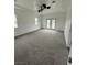 Bright bedroom with plush carpet, ceiling fan, and access to outdoor patio at 1830 Justine Ct, Pahrump, NV 89048