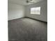 Empty bedroom with a neutral carpet, a ceiling fan, and a window with natural light at 1830 Justine Ct, Pahrump, NV 89048
