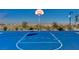 A basketball court has clear lines and is surrounded by low vegetation and mountain views at 2370 Via Firenze, Henderson, NV 89044