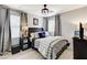 Comfortable bedroom with a modern ceiling fan, large windows, and a well-lit, cozy ambiance at 2370 Via Firenze, Henderson, NV 89044