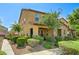 Exterior angle of home highlighting the manicured yard, stone accents, and inviting covered front porch at 2370 Via Firenze, Henderson, NV 89044
