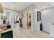 Bright hallway with modern flooring, leading to various rooms and featuring decorative accents at 2370 Via Firenze, Henderson, NV 89044