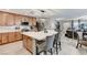 Spacious kitchen with white countertops, stainless appliances, and large island open to the living area at 2370 Via Firenze, Henderson, NV 89044