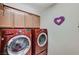 Laundry room equipped with modern, high-efficiency washer and dryer units at 2370 Via Firenze, Henderson, NV 89044