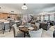 Open-concept living space seamlessly blends the living room, dining area, and kitchen for modern living at 2370 Via Firenze, Henderson, NV 89044