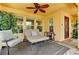 Cozy outdoor patio space with comfortable seating, a ceiling fan, and a tranquil ambiance at 2370 Via Firenze, Henderson, NV 89044