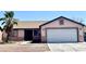 Charming single-story home featuring a well-kept yard with a palm tree and a two-car garage at 2405 Prime Advantage Ave, North Las Vegas, NV 89032