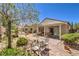 Well-maintained backyard with brick patio, mature landscaping, and covered seating area for outdoor enjoyment at 2540 Binary Stars St, Henderson, NV 89044