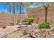 Picturesque backyard featuring a decorative rock landscape, brick patio, and seating area at 2540 Binary Stars St, Henderson, NV 89044